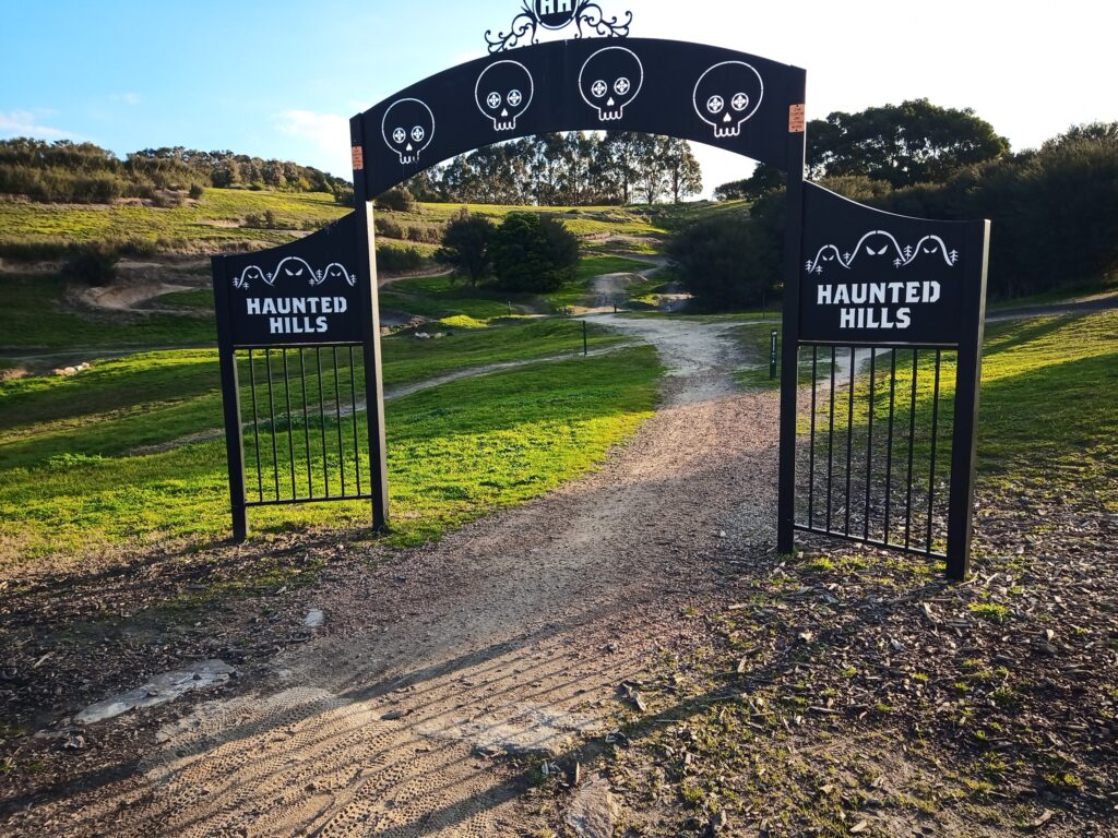 The ominous black gates emblazoned with skulls and ghosts at the entrance to Haunted Hills