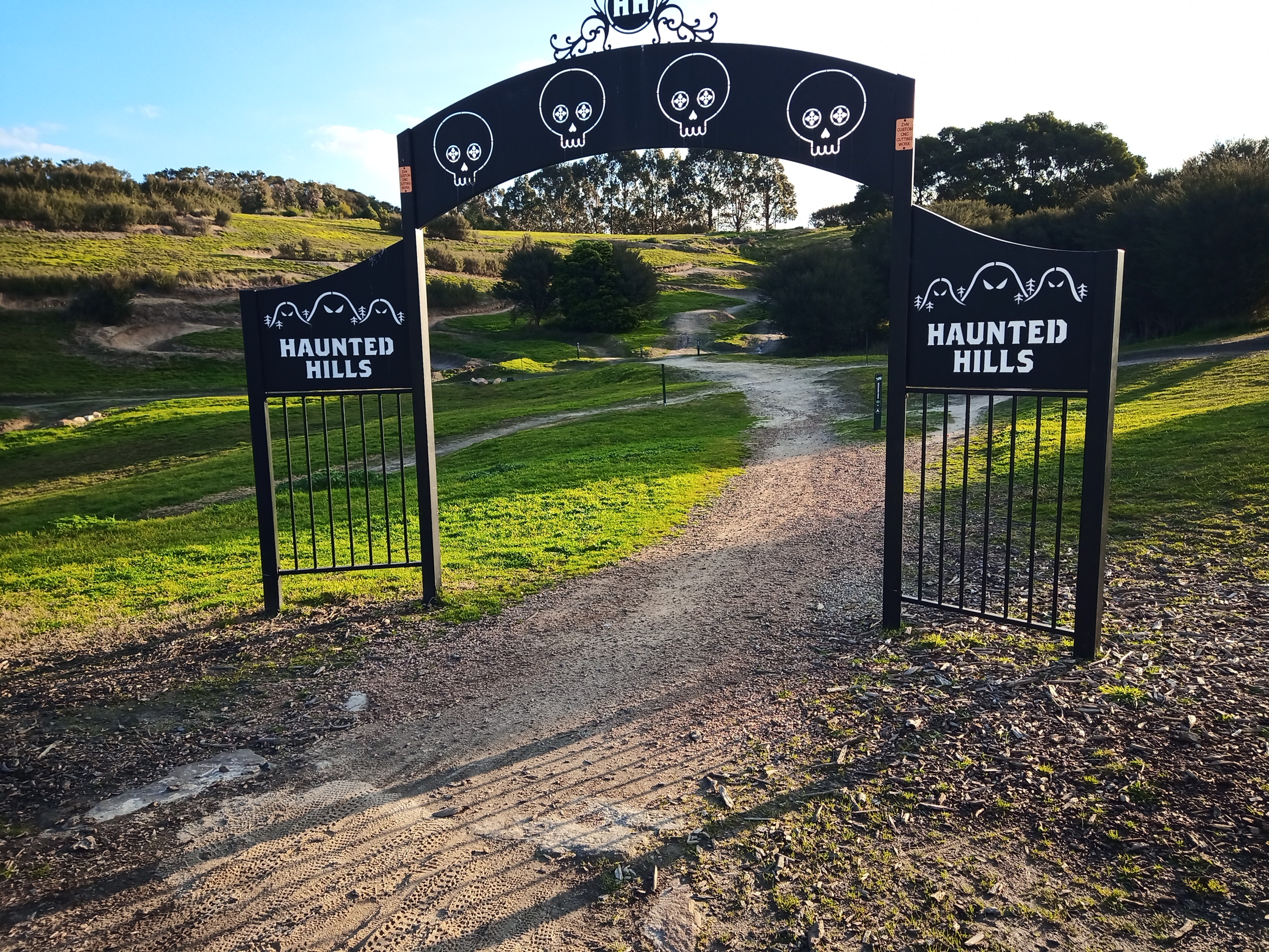 The ominous black gates emblazoned with skulls and ghosts at the entrance to Haunted Hills